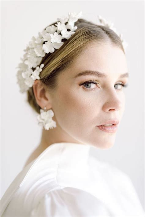a woman wearing a white flower headpiece