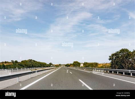 Paved road and beautiful green landscape in summer Stock Photo - Alamy