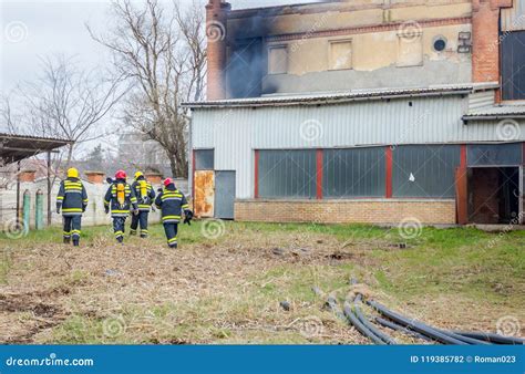 Firefighters are Oversees Burning Industrial Building, Ready for Stock Photo - Image of people ...