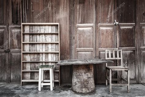 Wooden table,chairs,shelf in front of wooden house — Stock Photo © stockdevil_666 #61371847