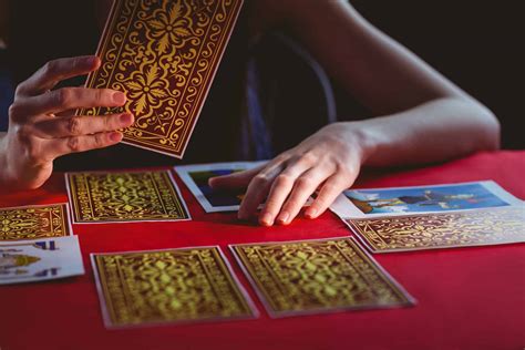 Fortune teller using tarot cards on black background