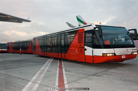 Red airport bus photo. Dubai International Airport, UAE