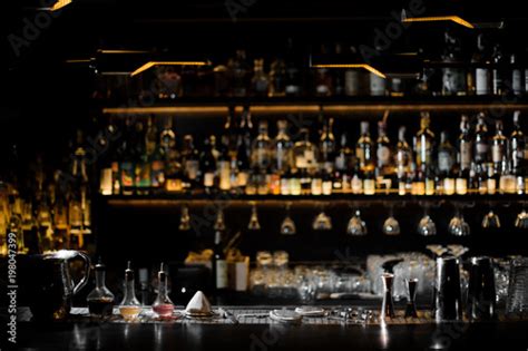 Blurred background of dark bar with barman essentials - Buy this stock photo and explore similar ...