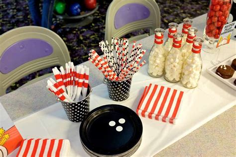 a table topped with lots of candy and cupcakes next to eachother