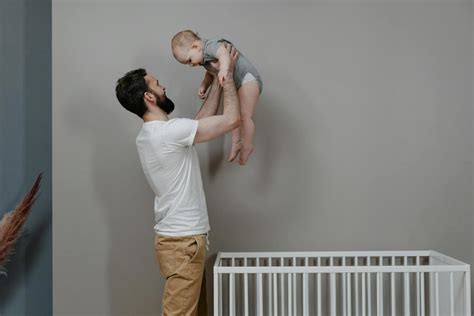 Man in White T-shirt and Brown Pants Carrying Boy in White T-shirt · Free Stock Photo