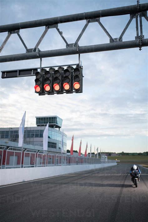 Start lights over racetrack with motorcyclist stock photo