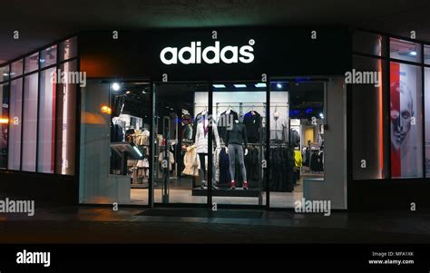 Adidas store at night in city Stock Photo - Alamy