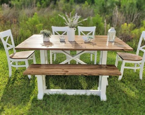 a wooden table and bench in the grass