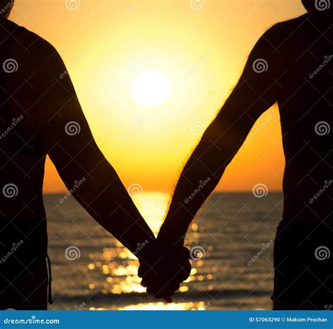 Couple At Sunset Holding Hands Stock Photo - Image: 57063290
