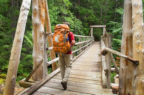 Hiker on suspension Bridge North Cascades - Alan Majchrowicz Photography