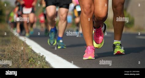 Marathon running race, runners feet on road Stock Photo - Alamy