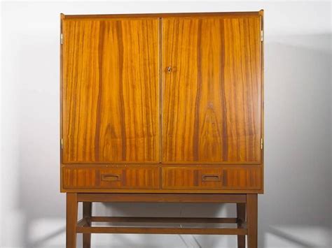 European Mid-20th Century Bar Cabinet with Interior Mirrors and Light Leather Dining Room Chairs ...
