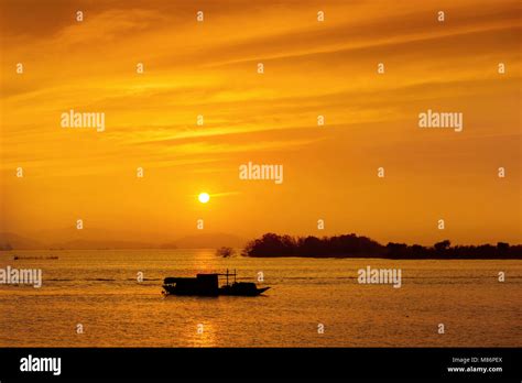 Silhouette of fishing boat at sea during sunset Stock Photo - Alamy