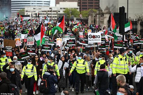 Pro-Palestine protesters in London wave signs saying 'Stop doing what ...