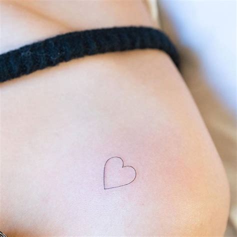 Minimalist heart tattoo on shoulder