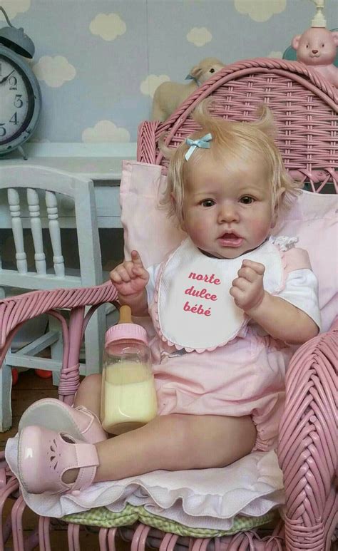 the text on her bib says: "norte dulce bébé" which is "our sweet baby" in French (With images ...