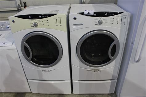 GE FRONT LOAD WASHER AND DRYER SET ON PEDESTALS