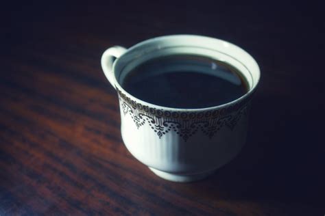 Black Beverage in White and Black Ceramic Mug · Free Stock Photo