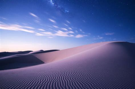 Premium AI Image | a desert with a sky full of stars