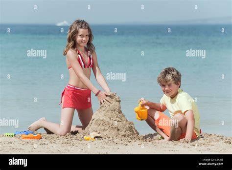 Spain, Mallorca, Children building sandcastle on beach Stock Photo - Alamy