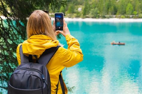 Premium Photo | Tourist takes photo of stunning lake braies in the ...