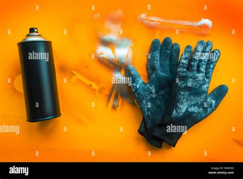 Black color spray can and gloves for graffiti artwork on grunge yellow background Stock Photo ...