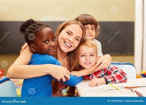 Happy Children Hug Their Educator Stock Photo - Image of childhood, drawing: 165193256