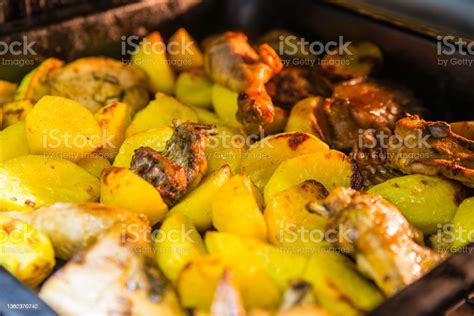Potatoes With Chicken Meat In The Oven On A Tray Side View Stock Photo - Download Image Now - iStock