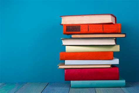 Stack of colorful books, grungy blue background, free copy space ...