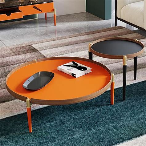 an orange coffee table sitting on top of a blue rug