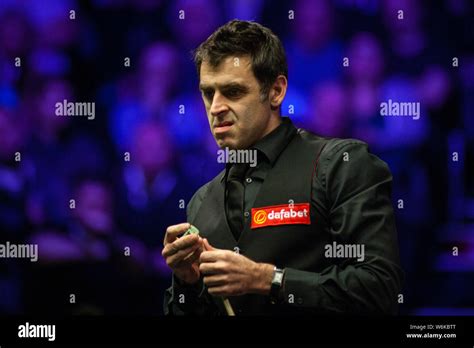 Ronnie O'Sullivan of England considers a shot to Marco Fu of Hong Kong ...