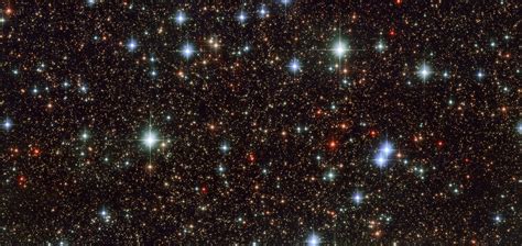 Hubble photo of the galactic center reveals colorful stars.