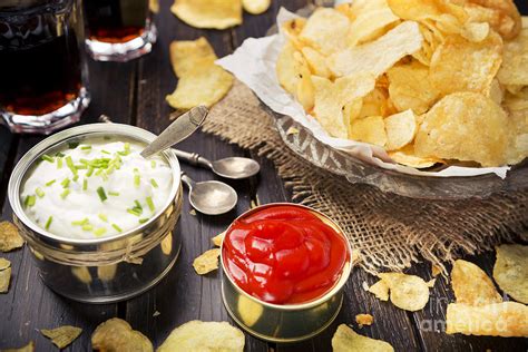 Potato chips with dipping sauces on a rustic table Photograph by Sara ...