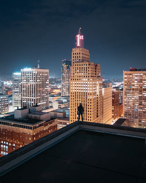 Person Standing at the edge of Building at Night · Free Stock Photo