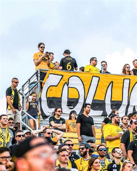 a group of people sitting in the stands at a soccer game