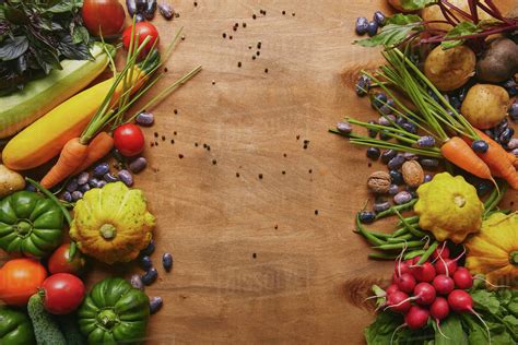 Frame of healthy food vegetables and beans on wooden table - Stock Photo - Dissolve