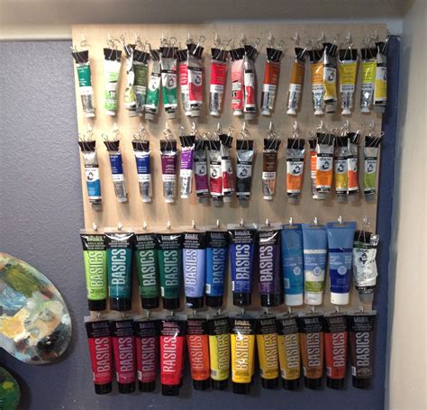 Easy solution to store and display oil and acrylic paints. Used 1/4" plywood with white cup ...