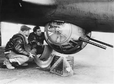 Ground crew loading 12,7 mm ammo in ball turret of B-17 bomber ...