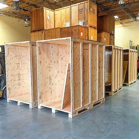 several wooden boxes are lined up in a warehouse