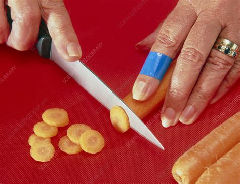 Detectable plaster on a cut finger - Stock Image - M330/0587 - Science Photo Library