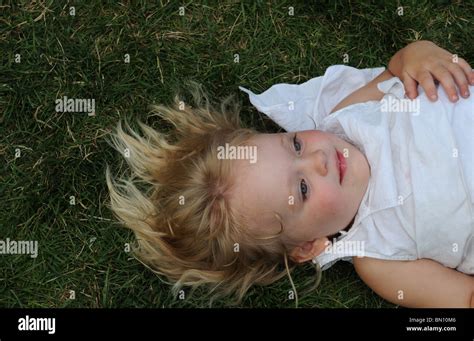 Girl lying in the grass on a summer day in Manhattan Stock Photo - Alamy