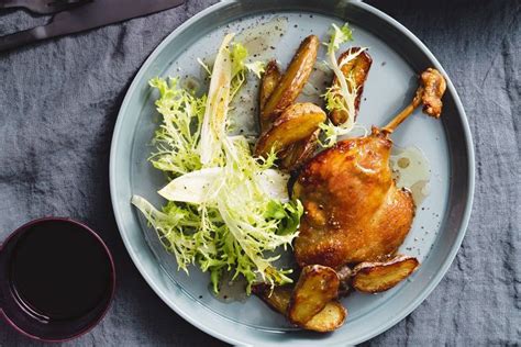 Duck confit with crispy potatoes and bitter leaf salad