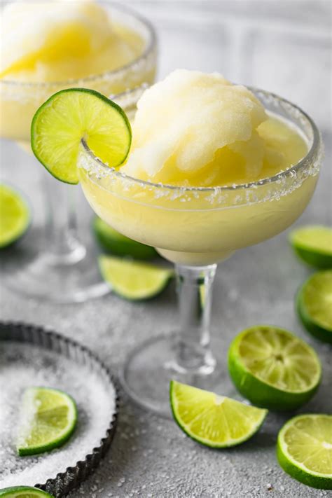 A frozen margarita served with a slice of lime | Margarita recipe frozen, Frozen margaritas ...