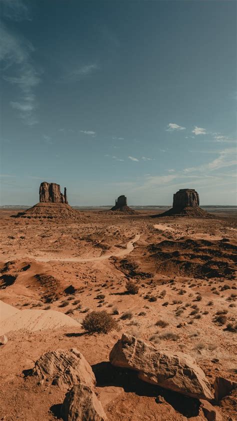 brown rock formation under white clouds during day... iPhone Wallpapers Free Download