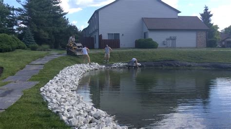 Pond Shoreline Erosion Control with Rip Rap Stone Installation - YouTube