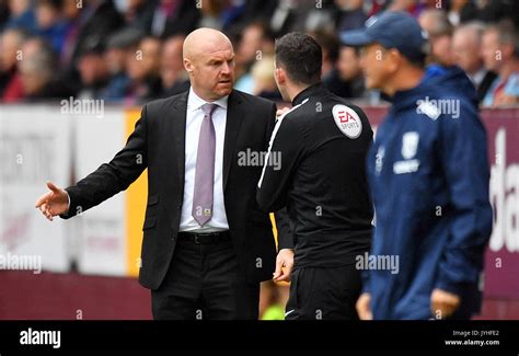 Burnley manager Sean Dyche speaks with the fourth official during the ...