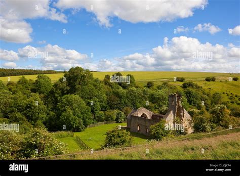 wharram percy church ruins from a hillside under a blue summer sky in ...