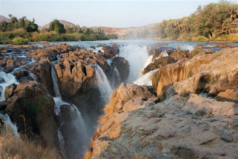 View of Epupa Falls at Sunset. Forest in the Background Stock Image - Image of light, beautiful ...