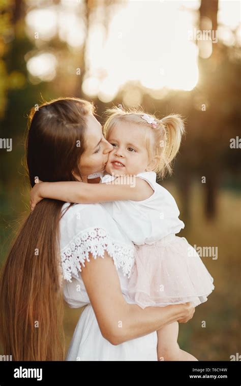 Young mother taking care of her little baby girl. Beautiful mom and her ...