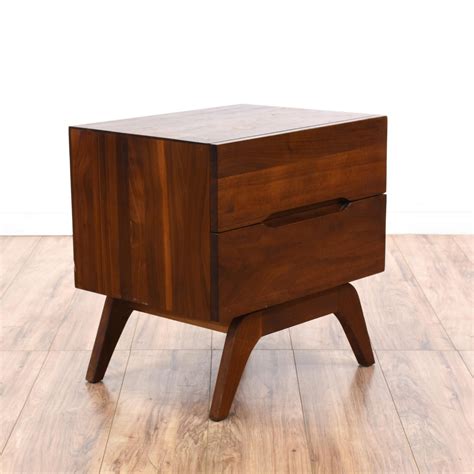 This mid century modern nightstand is featured in a solid wood with a ...